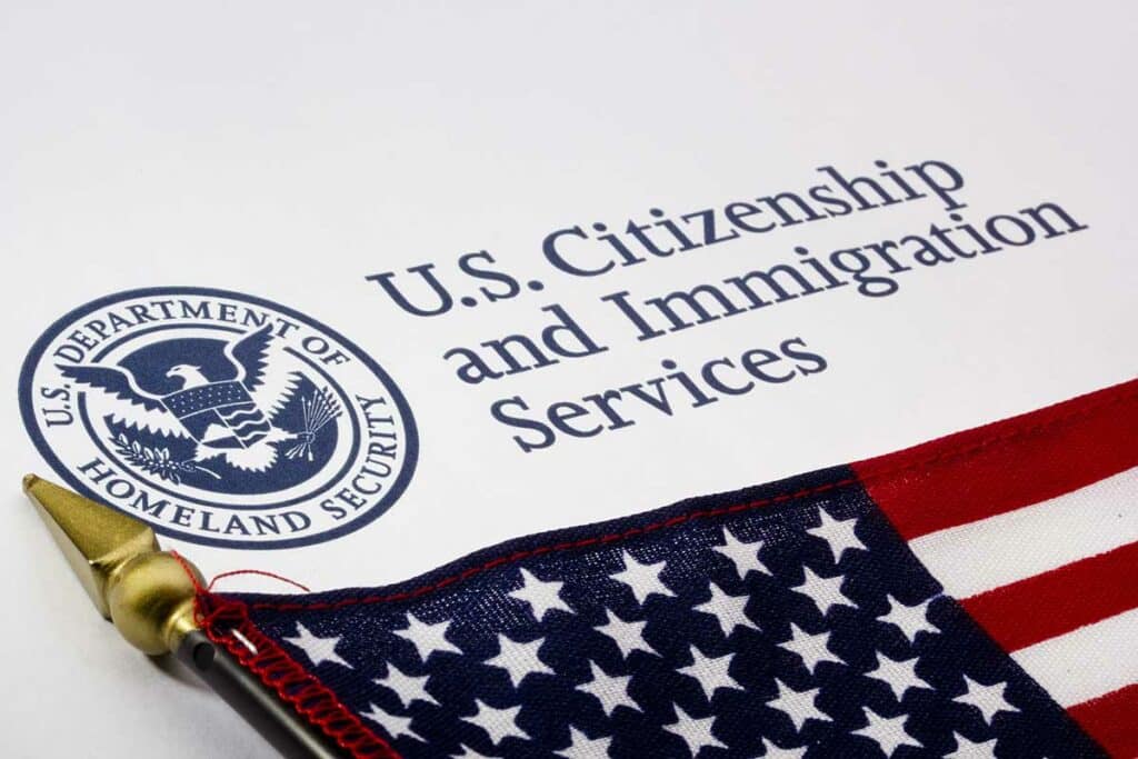 A small American flag on top of a U.S. Citizenship and Immigration Services letterhead
