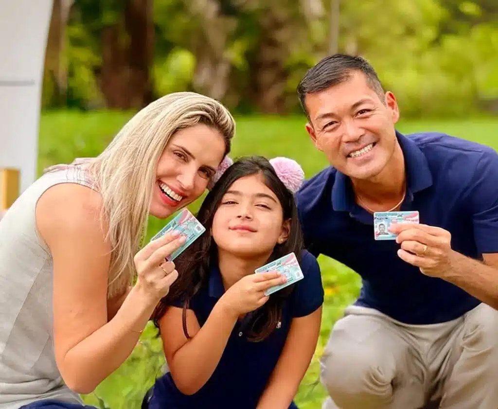 Happy family holding a Green Card