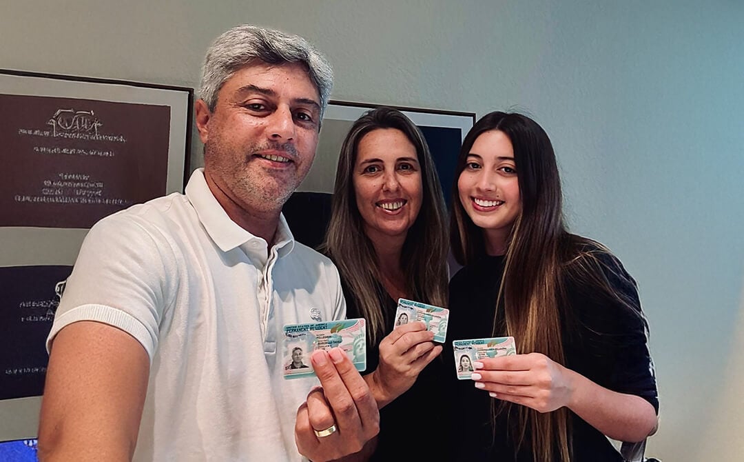 family_holding_green_cards